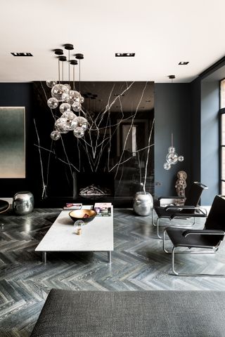 a living room with a black marble fireplace