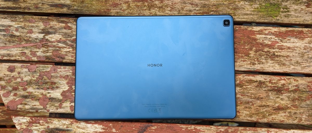 A blue-backed Honor Pad X8 tablet on a wooden table