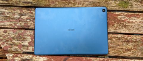 A blue-backed Honor Pad X8 tablet on a wooden table