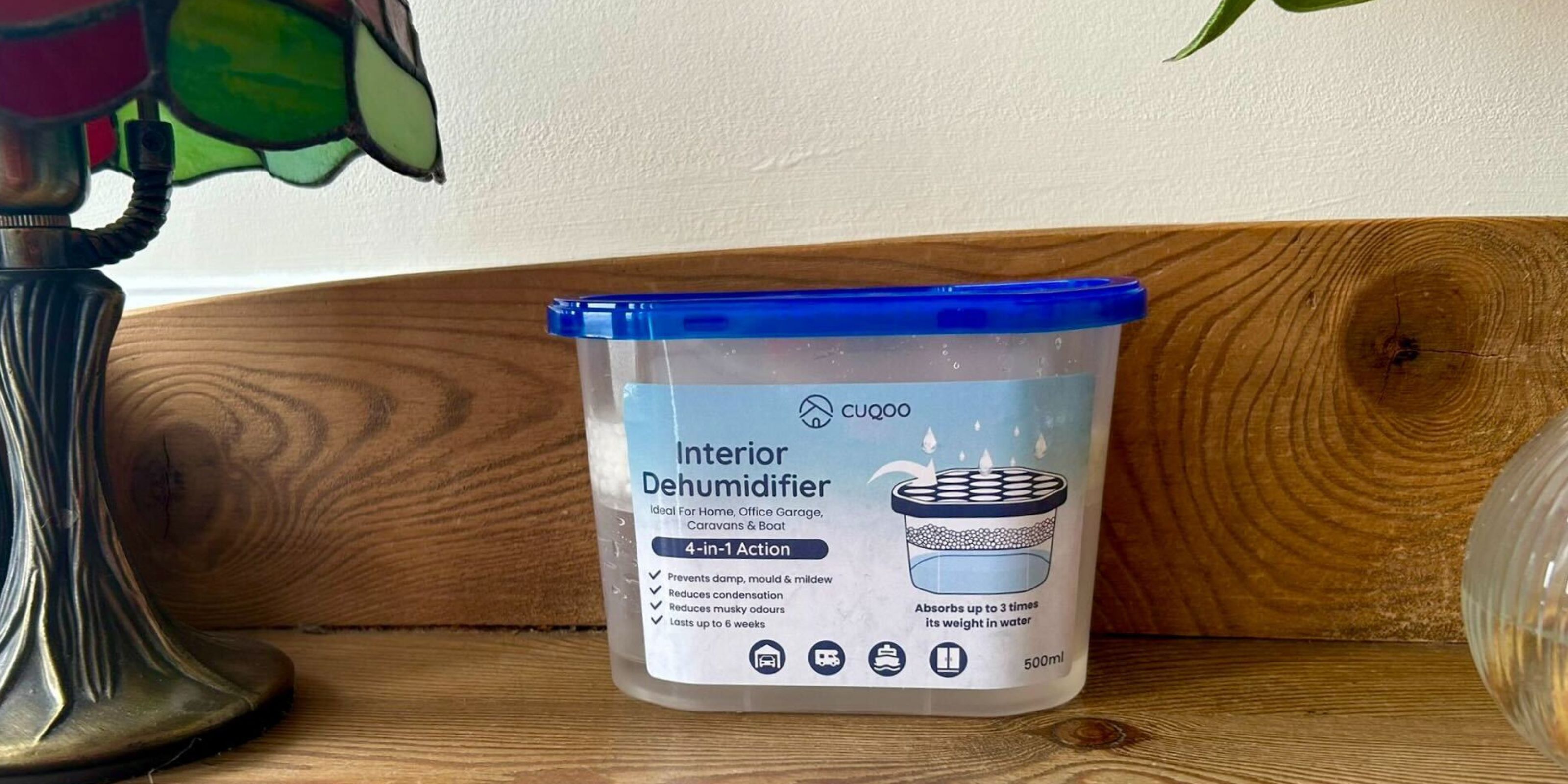 Disposable dehumidifier on wooden shelf with lamp next to it