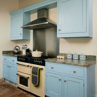 kitchen with blue coloured and cooker and chimney