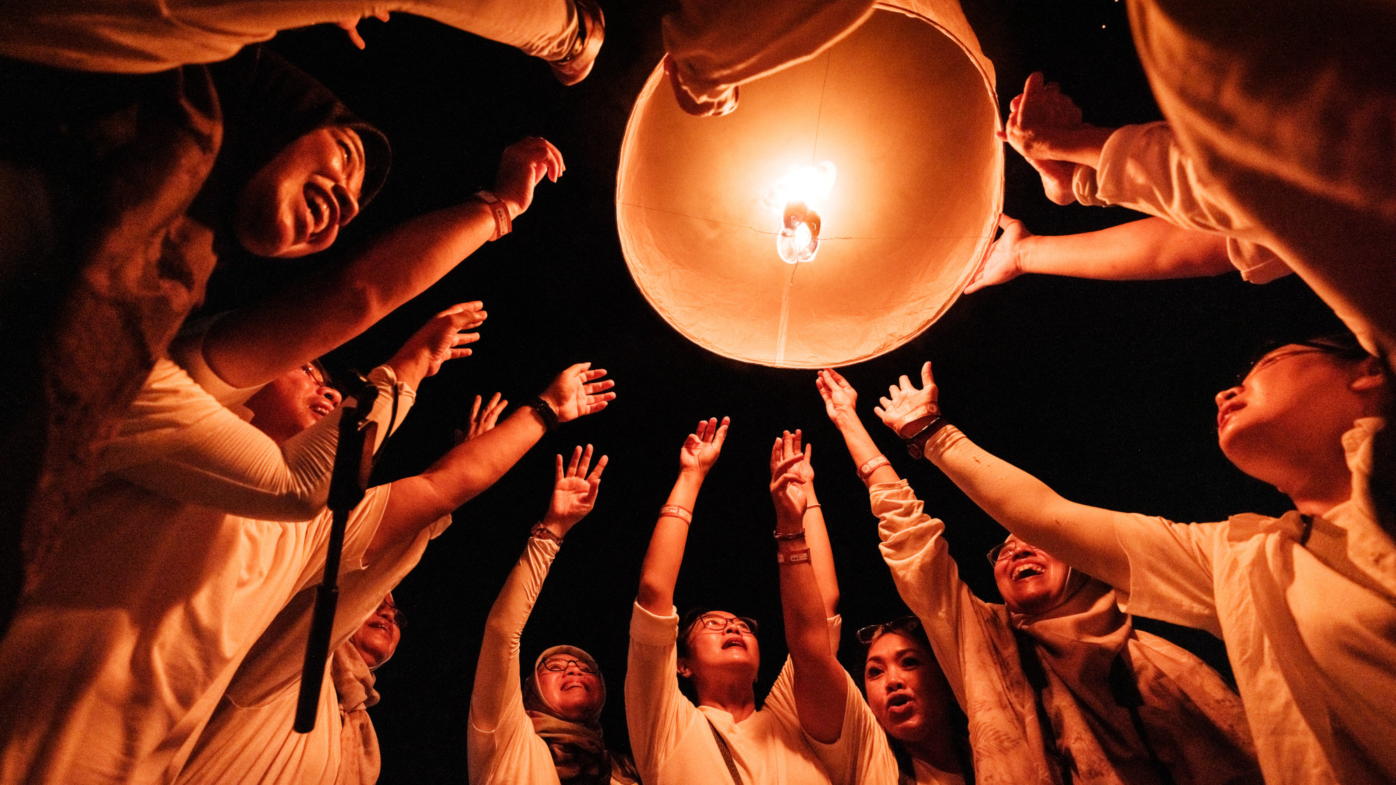 People release a lantern into the sky