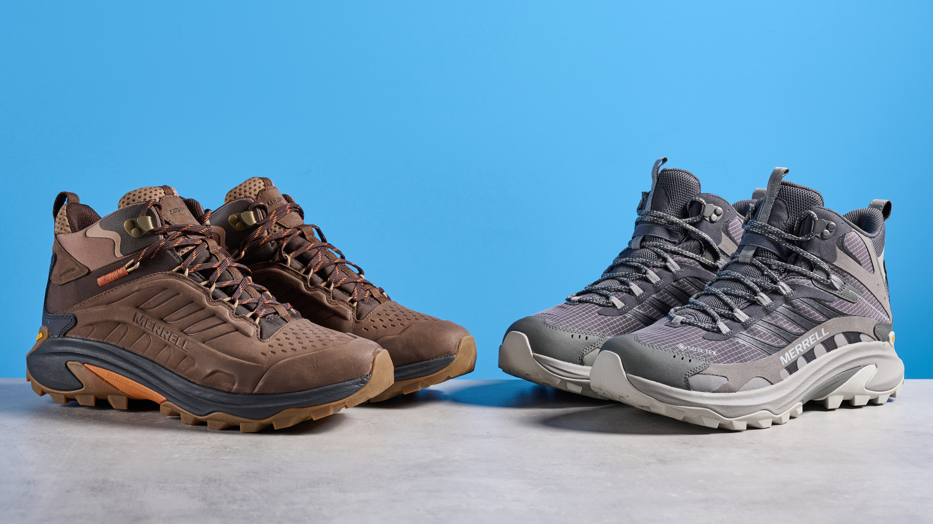 A photo of the Merrell Moab Speed 2 boots against a blue background