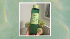 Hand holding green Pixi Antioxidant Tonic bottle, on a green watercolour background