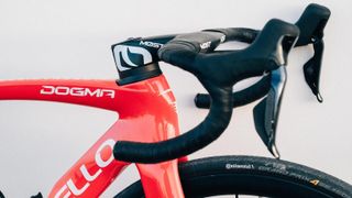 Pinarello Dogma frame in Team Ineos red against a wall