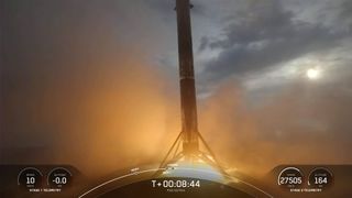 SpaceX rocket landing on drone ship at sea with flames