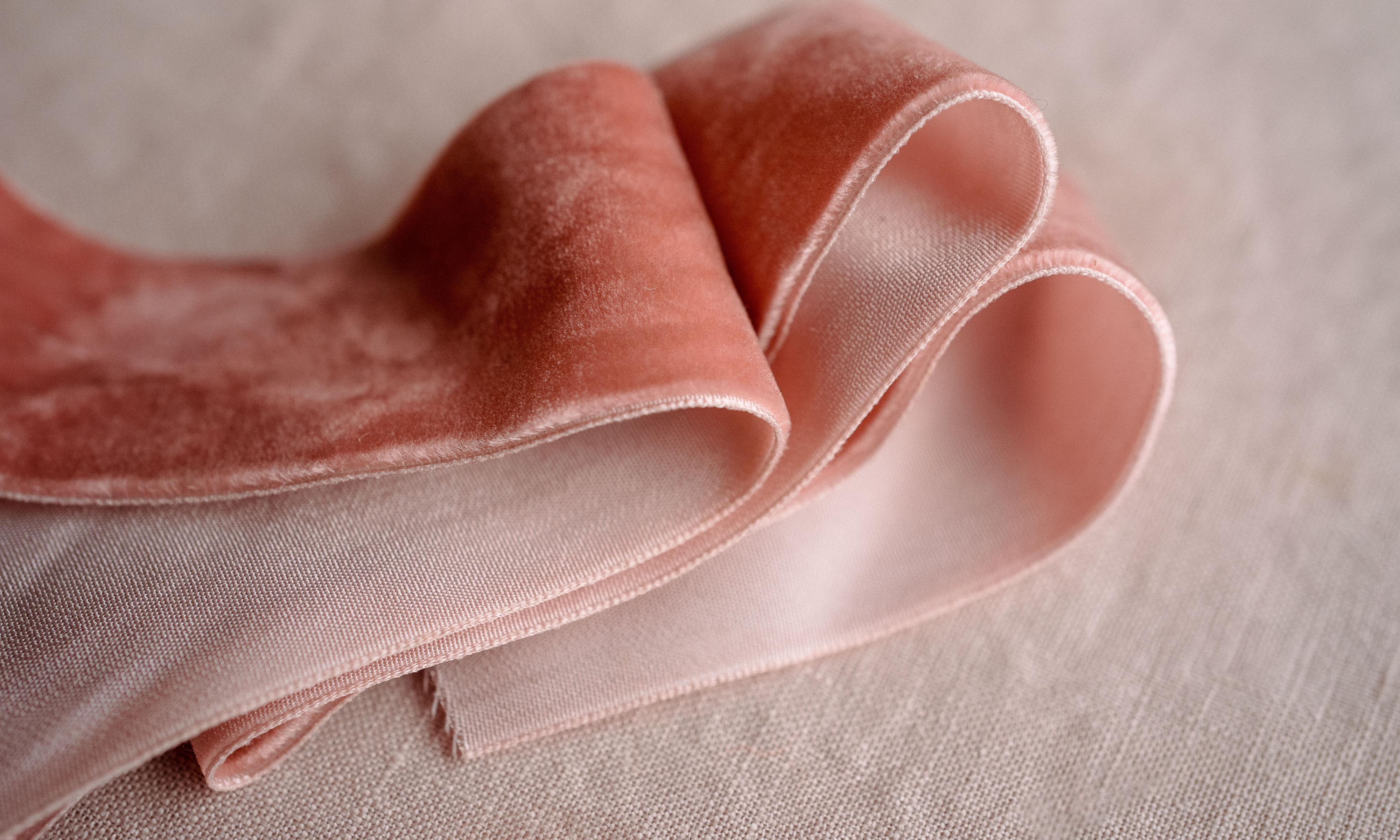 Pink velvet ribbon folded on a table