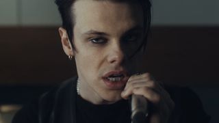 Yungblud holding microphone in music video for Zombie