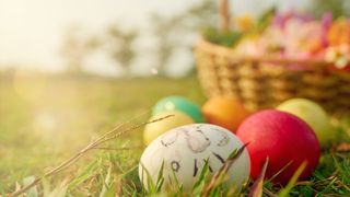 Image of eggs and a basket on grass as part of Easter games