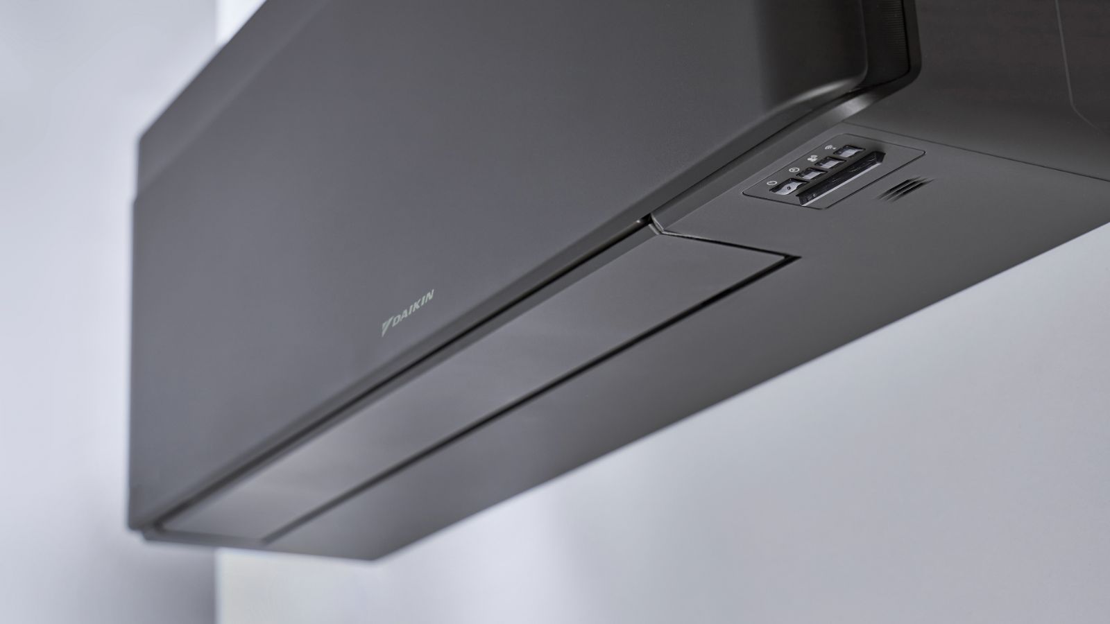 A black wall mounted air conditioning unit 