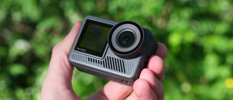 Akaso Brave 8 Lite action camera held in a hand outside