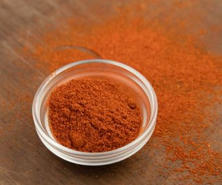 Chili powder on a wooden table