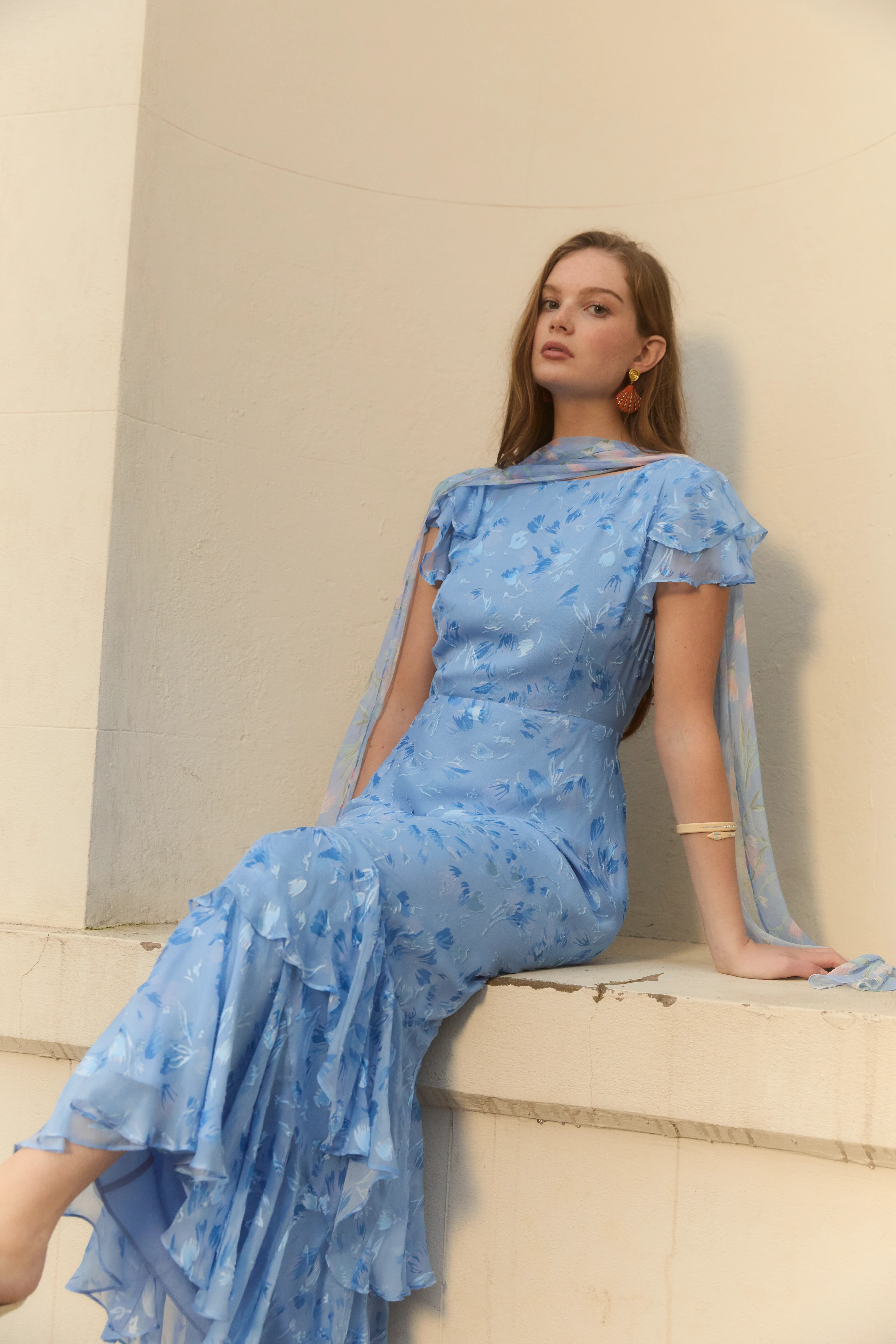 A model wearing a blue Rixo bridesmaid dress.