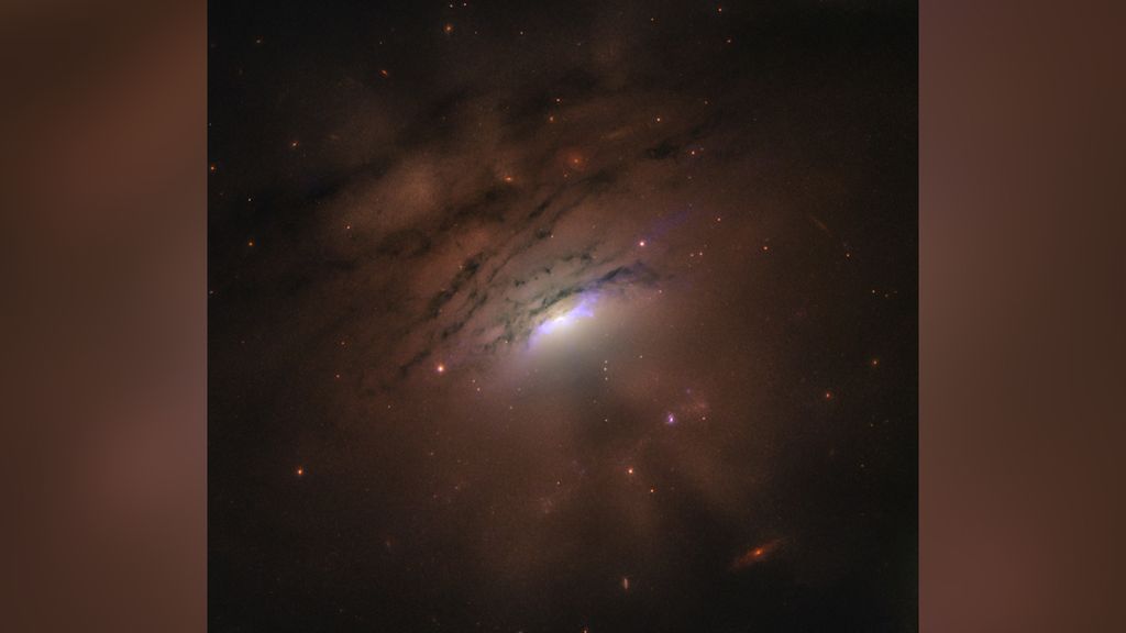 Hubble captures a black hole's 'shadow beams,' yawning across space