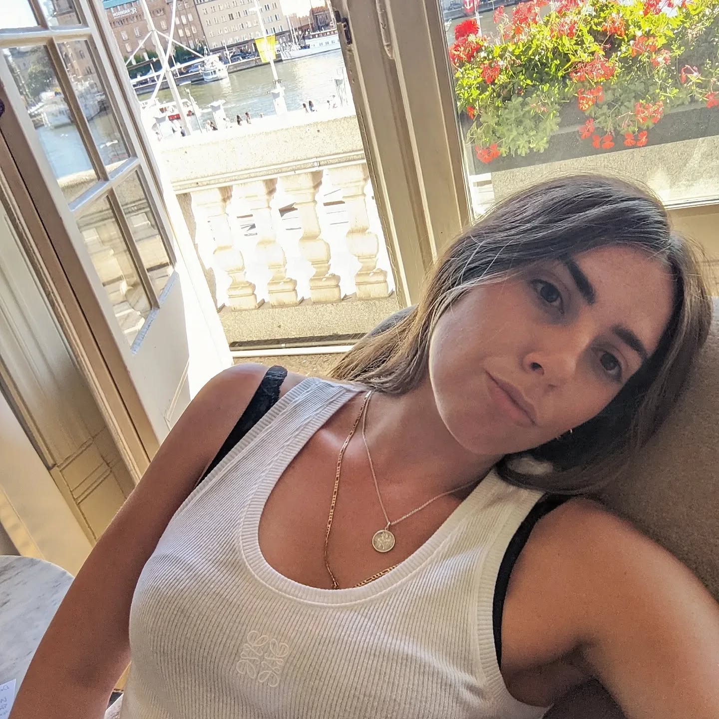 An image ofBest Knockoff Luxury Clothing
's Shannon Lawlor wearing a Loewe white tank top.