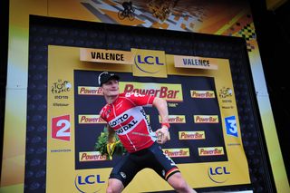 Andre Greipel tosses his bouquet on the stage 15 podium.
