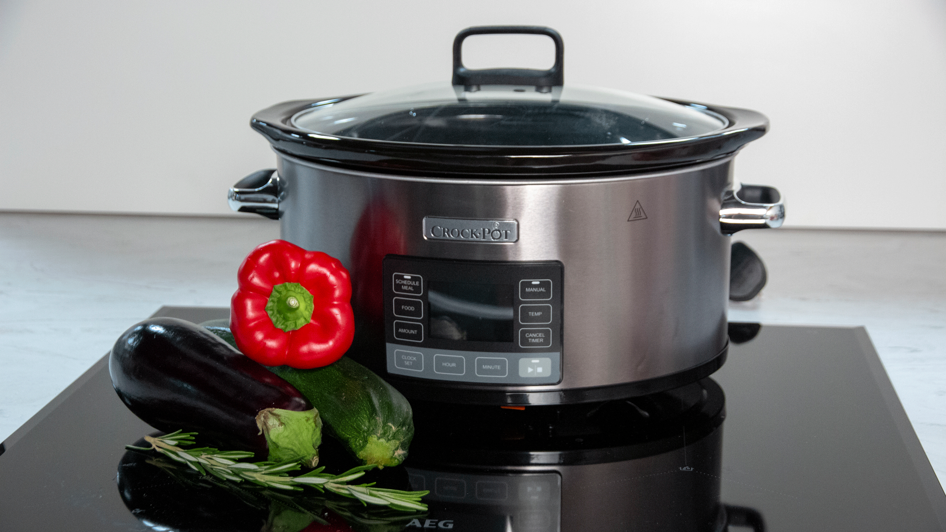 Black slow cooker on a hob