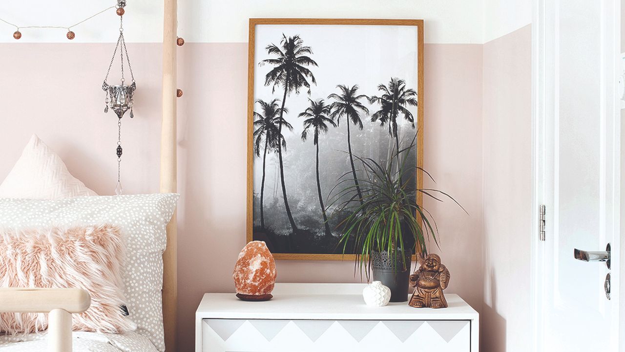 Bohemian bedroom with a buddha statue and salt lamp