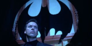 Bruce Wayne (Michael Keaton) stares at the Bat-signal