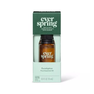 An amber essential oil bottle in mint green packaging, with a dark green label that says 'everspring' at the top