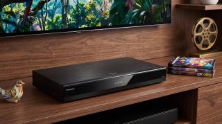 Panasonic DP-UB820 4K Blu-ray player on an entertainment unit.