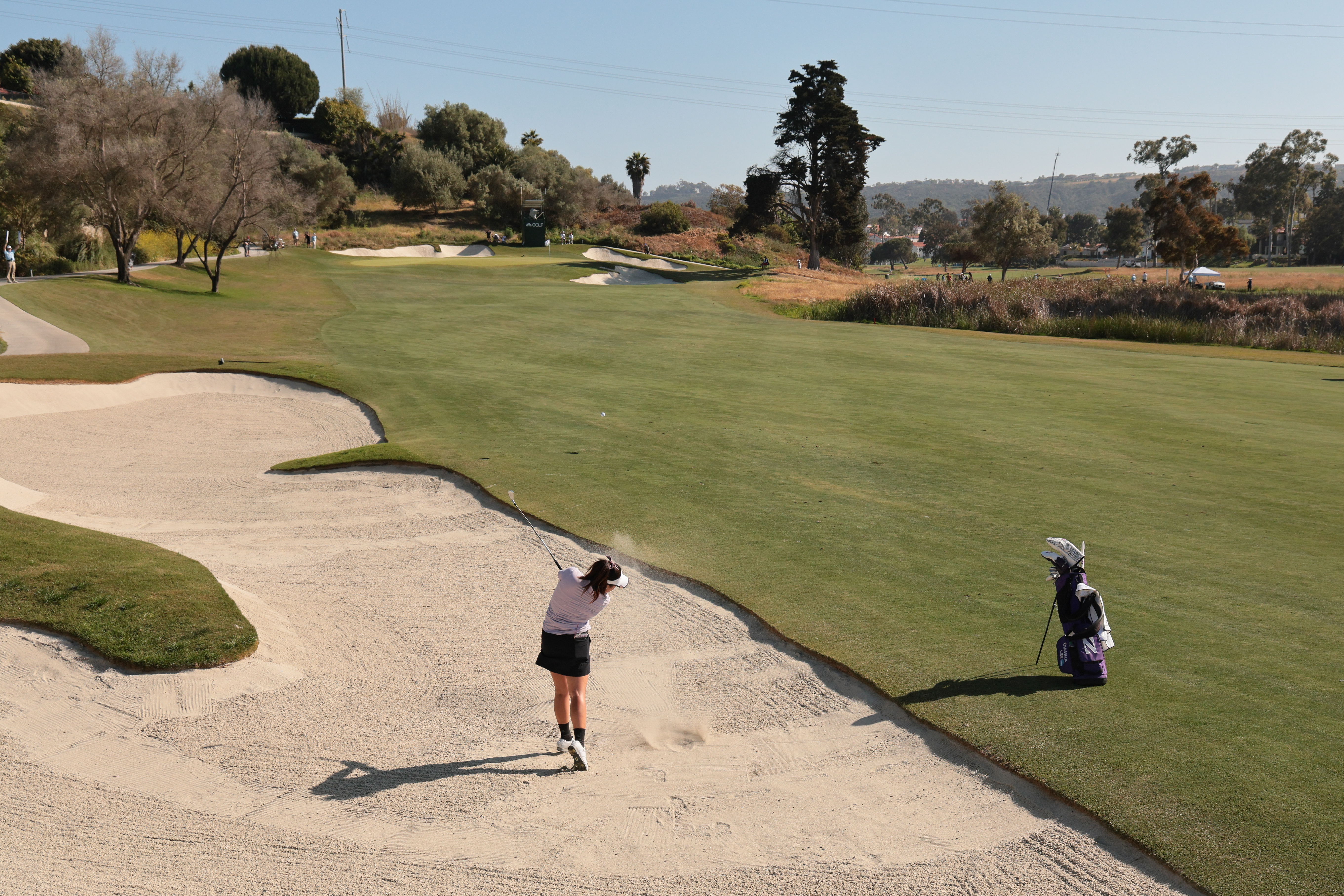 A golfer hits out of a fairway bunker during the 2025 NCAA D1 Women&#039;s Golf Championship at Omni La Costa Resort &amp;amp; Spa