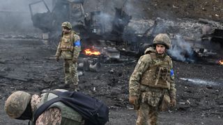 26 February: Ukrainian servicemen search for unexploded ordnance following clashes with Russian troops on the outskirts of Kyiv