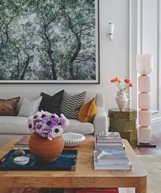 living room with cream sofa and burl coffee table and artwork