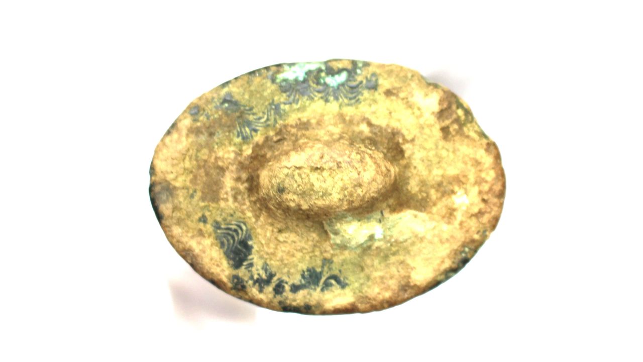 The pommel is decorated with the same engraved marks seen on the hilt. Archaeologists think the sword and the axe it was found with may have had a religious purpose.