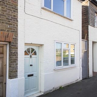 house with brick walls white doors and sliding white windows