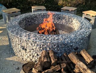 circular DIY fire pit made from stone filled gabions