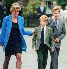 Princess Diana, Prince Harry and Prince William walking outside at Eton College in suits