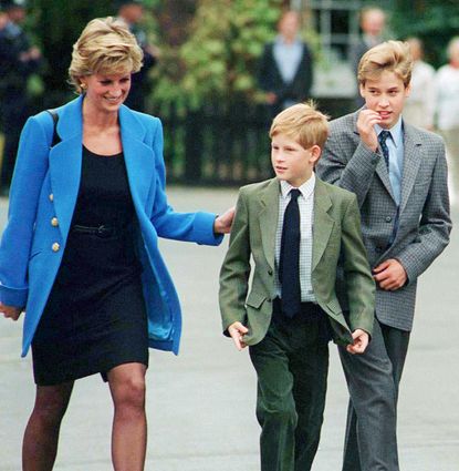 Princess Diana, Prince Harry and Prince William walking outside at Eton College in suits