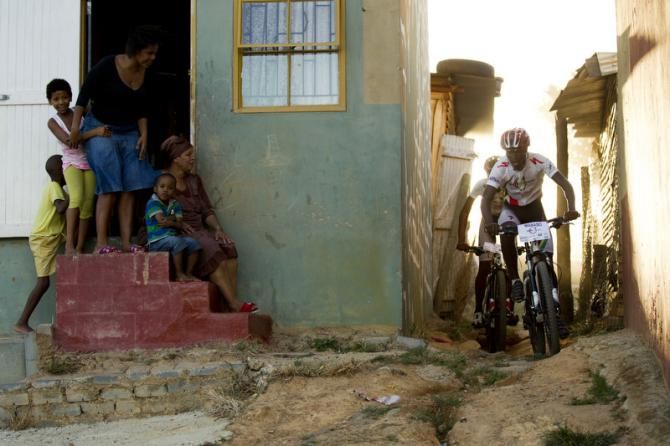 Racers squeeze through a tight spot on the course