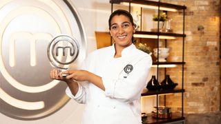 Nikita holding the MasterChef: The Professionals trophy in season 15