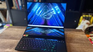 Asus ROG Zephyrus Duo 16 gaming laptop open on a wooden table