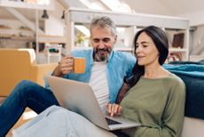 Mature couple working from their living room.