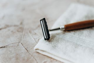 A shaving razor perched on a white face cloth