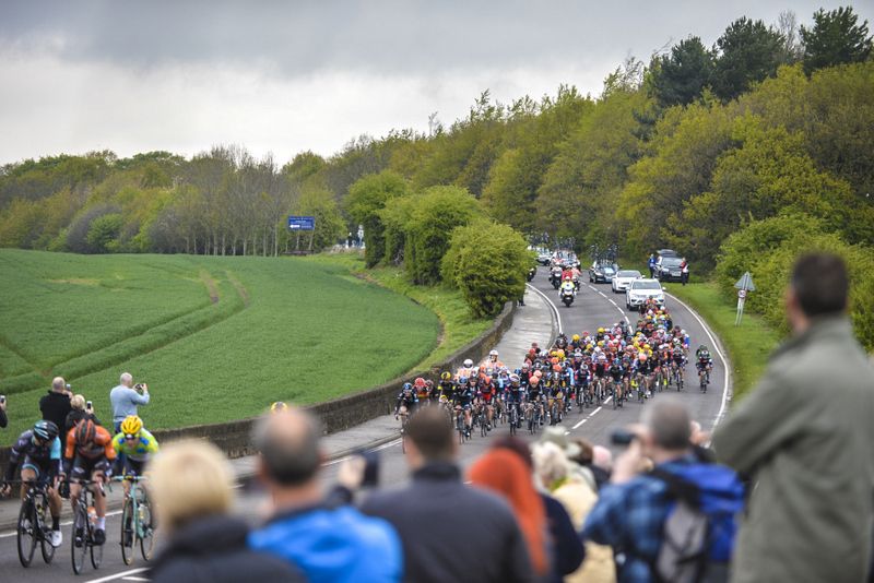 The peloton passes through the green Wakefield