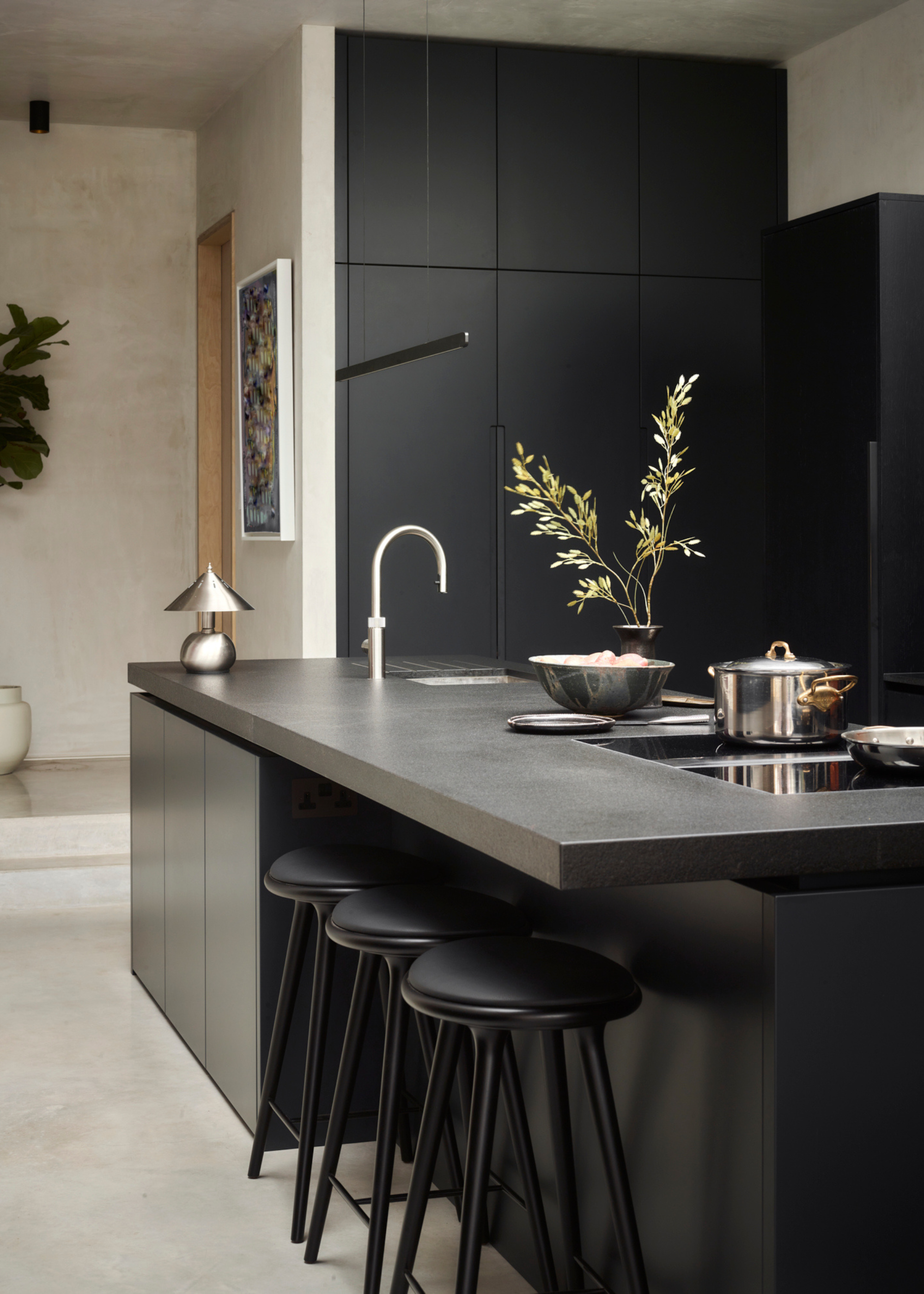 sleek all black kitchen island with overhang for seating