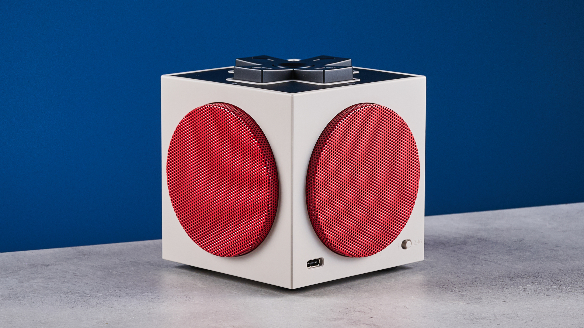 A beige, red and black 8BitDo Retro Cube 2 Bluetooth speaker