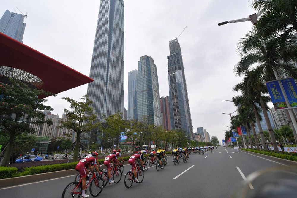 The riders enjoyed the wide roads and tall skyscraper