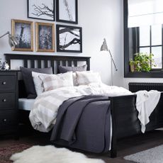 ikea bedroom with pillows on bed in bedroom lamp on bedside table and photo frame on wall