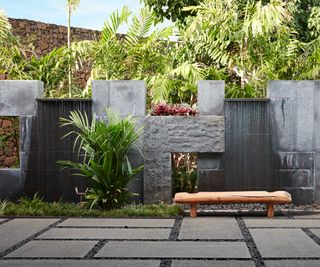 modern paved backyard with feature wall and waterfall