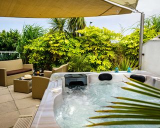 hot tub in garden with canopy