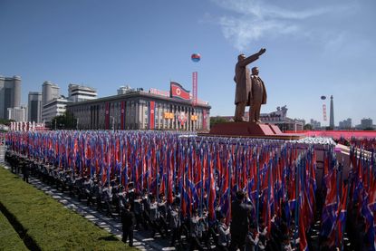Students march past a balcony from where North Korea's leader Kim Jong Un was watching, during a mass rally on Kim Il Sung square in Pyongyang on September 9, 2018. 