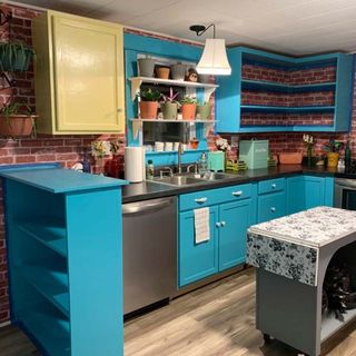 monica from friends-inspired kitchen with blue cabinetry and open shelving