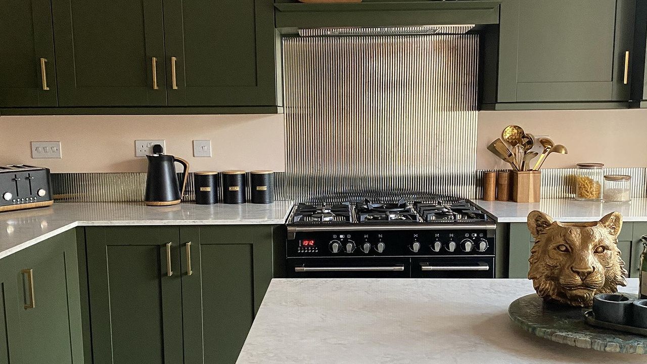 green kitchen with island and range cooker