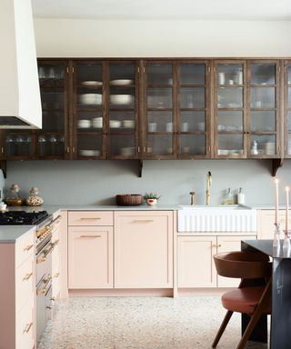 Modern farmhouse kitchen with glass fronted cabinets, farmhouse sink and creamy neutral colored paint