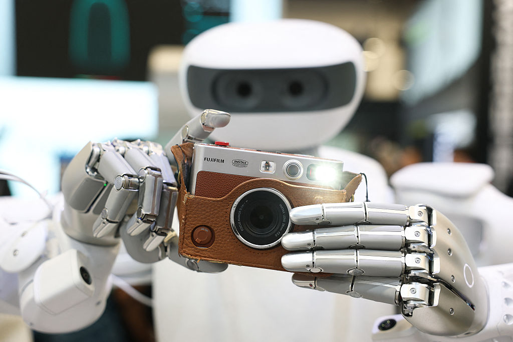 The Sharpa robot takes a photograph with a Fujifilm instax camera during the annual Consumer Electronics Show (CES) in Las Vegas, Nevada on January 6, 2026.
